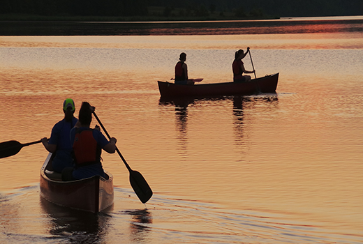 学生们在日落时分在约翰·坦纳划船