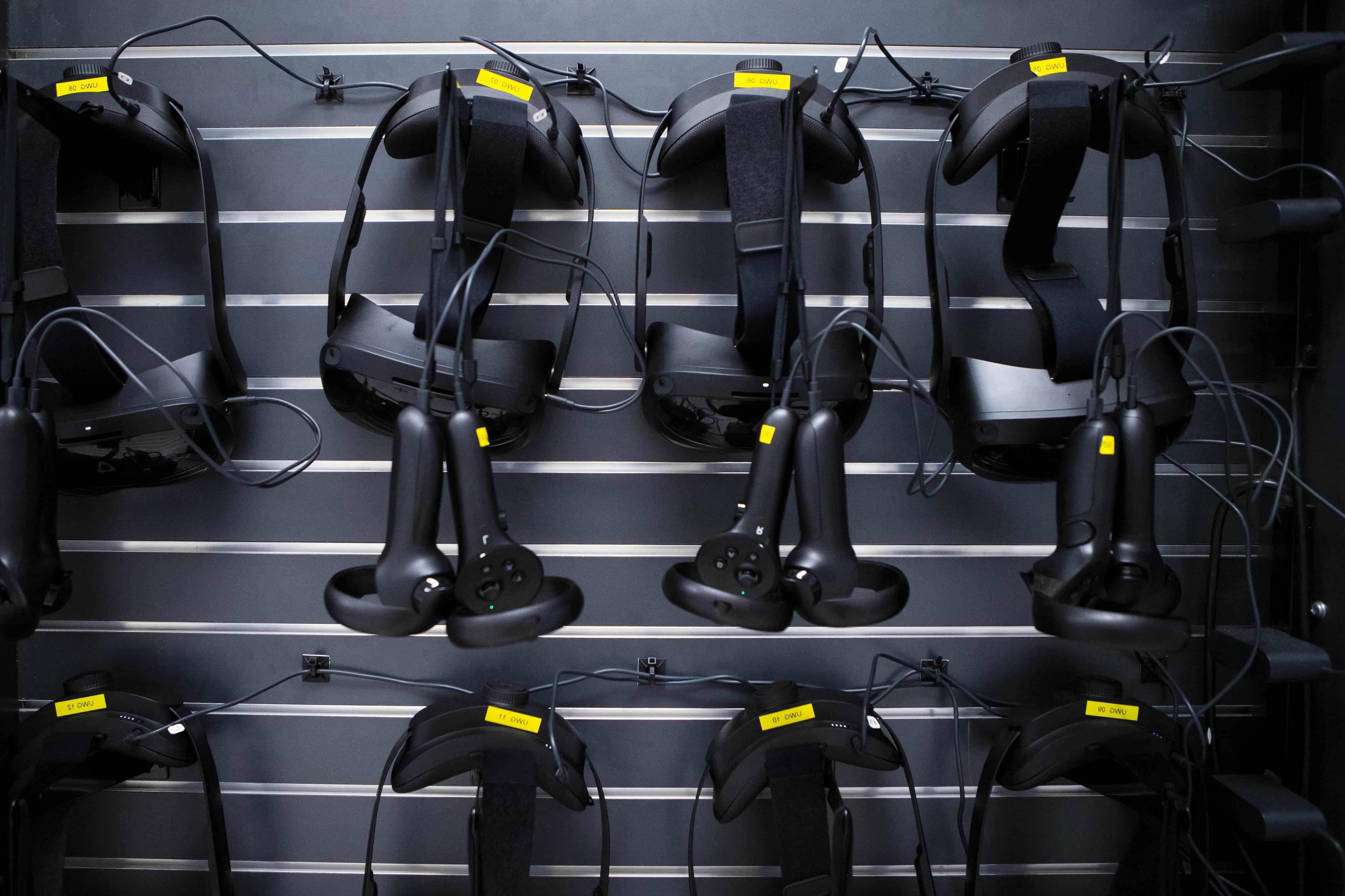 Virtual reality headsets hanging on a wall.